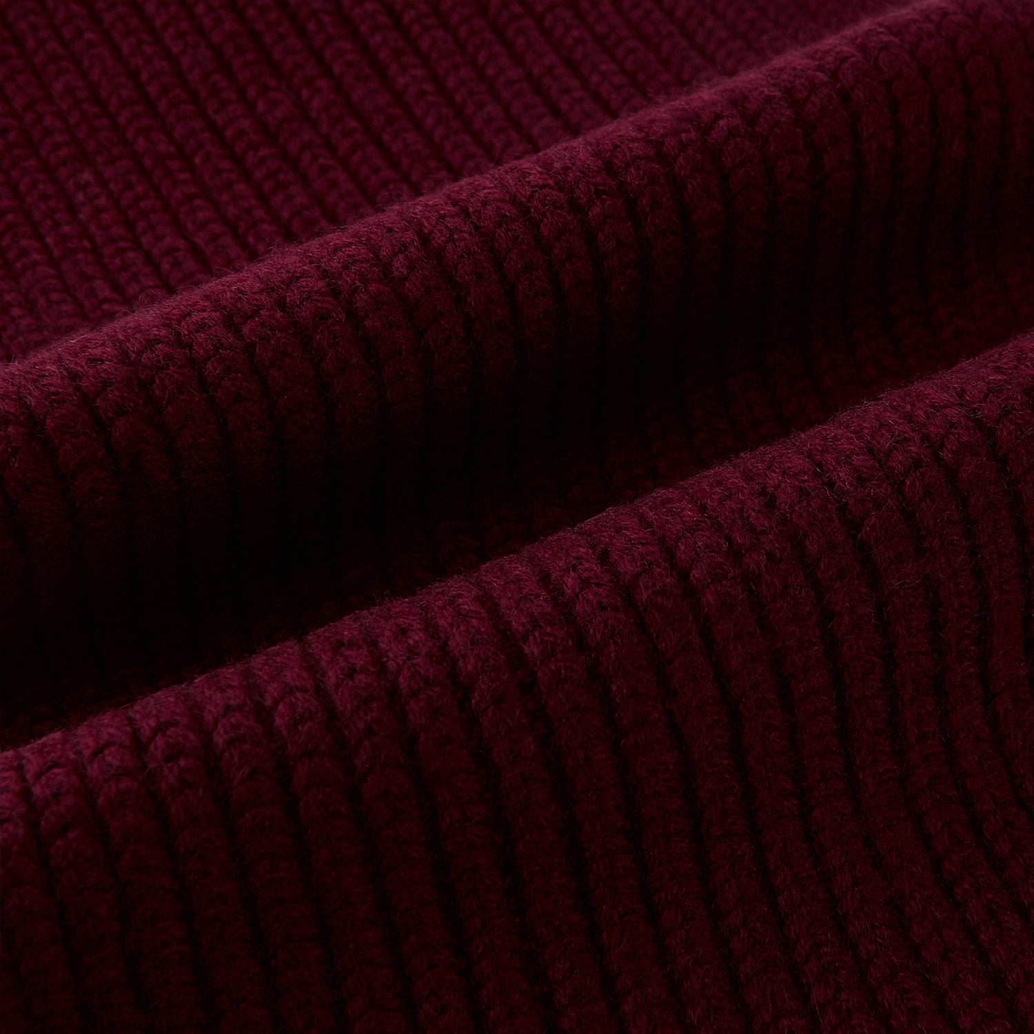Image 3 of product The Burgundy Rib-Knit Cashmere Scarf by Turnbull & Asser is crossed at the center and set against a plain light gray background—an elegant, luxurious winter accessory.
