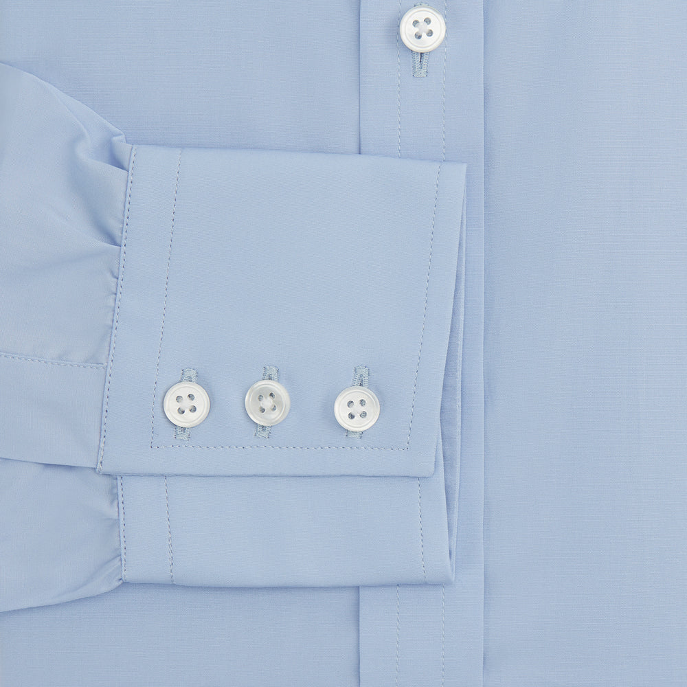 The Turnbull & Asser Blue Cotton Shirt features a T&A collar, 3-button cuffs, and white buttons—ideal for navy suits or smart looks. Laid flat on a white background.