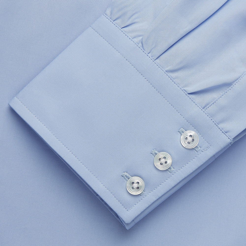 Turnbull & Asser's Tailored Fit Blue Cotton Shirt features a Kent collar, 3-button cuffs, and a clean design—ideal with a navy suit. Displayed on a plain white background.
