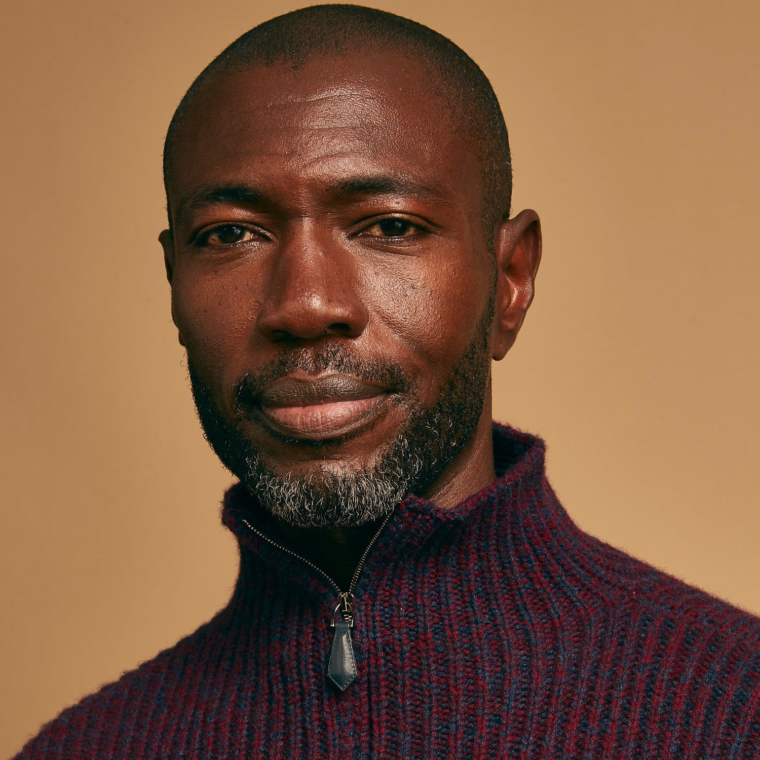 View 5 of product The Turnbull & Asser Burgundy Mullion Half Zip Rib Cashmere Jumper features a high collar and half-zip front in dark red and navy cashmere, shown laid flat on a white background—ideal for an elevated casual look.