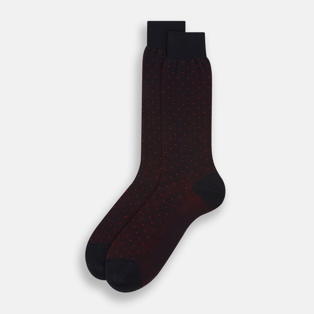 The Turnbull & Asser Navy/Red Polka Dot Mid-Length Sock is shown against a white background, featuring small red dots and solid black cuff, heel, and toe for classic style.