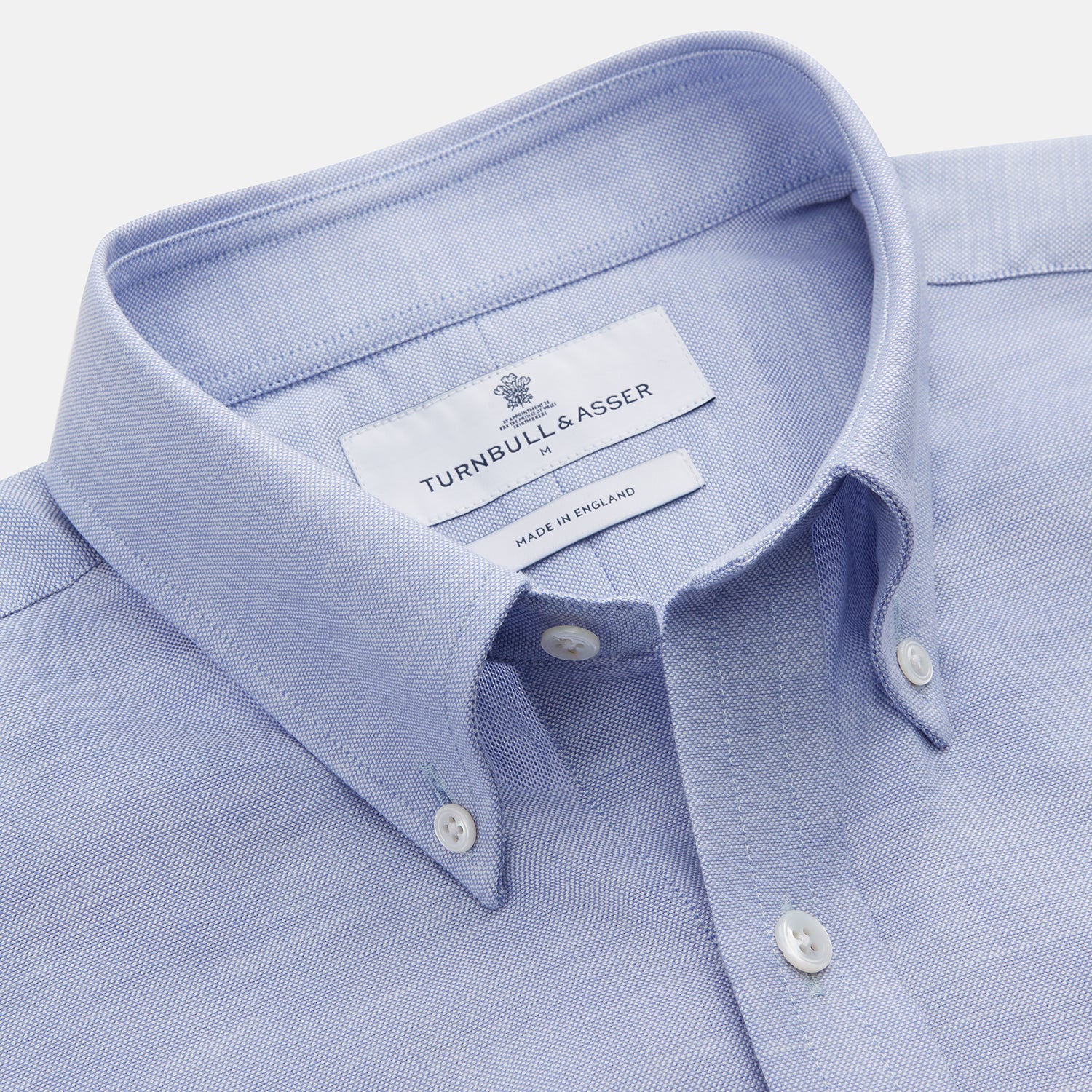 View 2 of product The Turnbull & Asser Pale Blue Weekend Fit Hayne Shirt features a Dorset collar, white buttons, and 1-button cuffs. This casual, long-sleeve button-down is displayed laid flat on a white background.