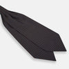 View 3 of product The Turnbull & Asser Blue and Dark Brown Micro Dot Silk Cravat features evenly spaced blue micro dots on dark brown silk, displayed neatly folded on a white background.