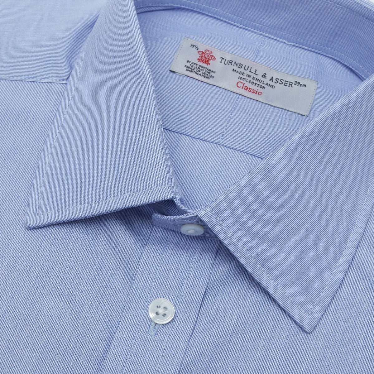 View 5 of product The Turnbull & Asser Blue Hairline Stripe Shirt features a T&A collar, 3-button cuffs, and subtle stripes, displayed neatly folded against a plain white background.