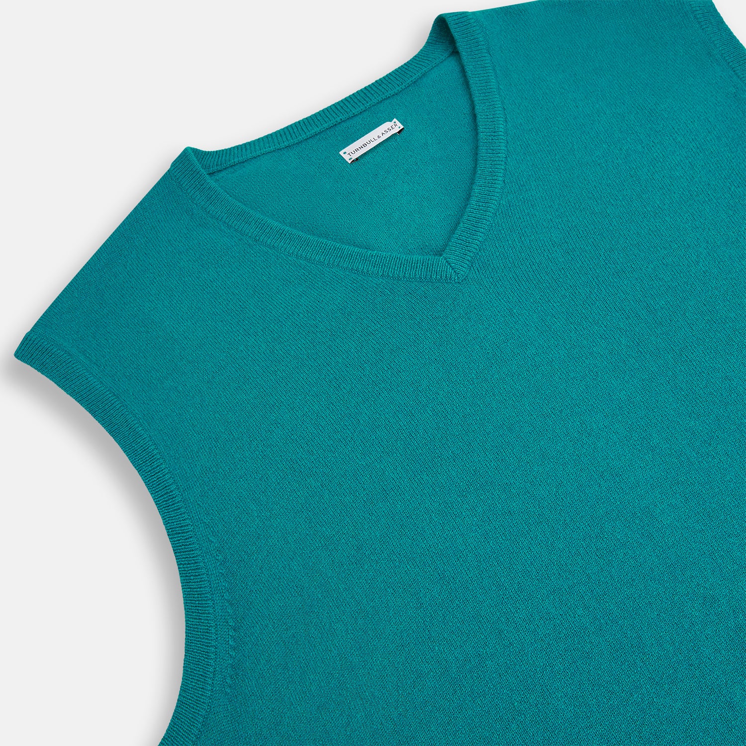 View 2 of product The Turnbull & Asser Turquoise Cashmere V-Neck Vest features ribbed detailing at the neck, armholes, and hem. Shown on a white background, its soft cashmere fabric brings refined charm to any distinguished look.