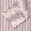 View 4 of product The Turnbull & Asser Burgundy Stripe West Indian Sea Island Cotton Regular Fit Mayfair Shirt features thin vertical red and white stripes, a classic collar, and long sleeves, shown on a plain white background.