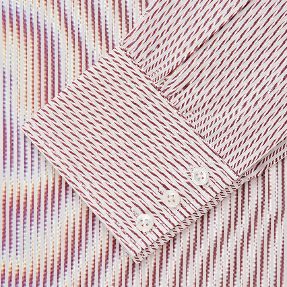 The Turnbull & Asser Burgundy Stripe West Indian Sea Island Cotton Regular Fit Mayfair Shirt features thin vertical red and white stripes, a classic collar, and long sleeves, shown on a plain white background.
