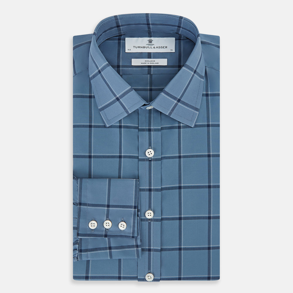 The Turnbull & Asser Steel Grey Grid Check Mayfair Shirt is a long-sleeve, button-up shirt in light blue Italian cotton, shown against a plain white background.