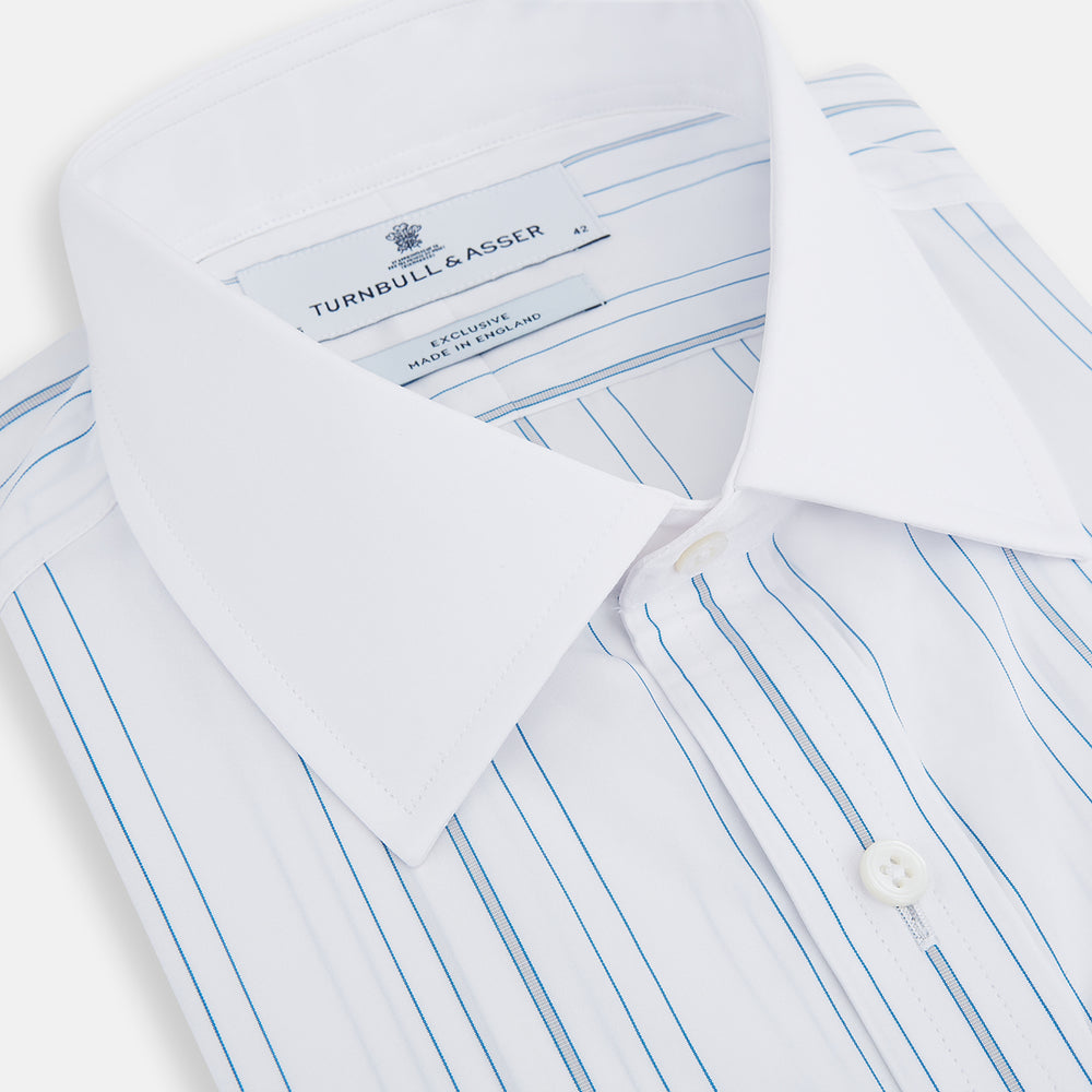 The Turnbull & Asser Pale Blue Multi Stripe Shirt features thin vertical stripes, a contrast collar, and double cuffs, displayed on a plain light background.