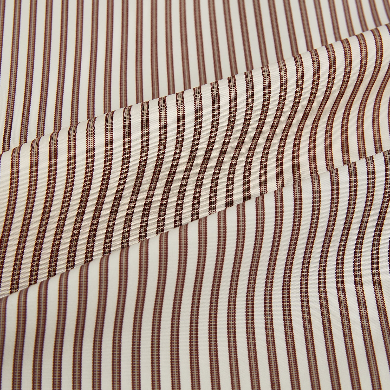 View 8 of product The Burgundy Halo Stripe Westminster Shirt by Turnbull & Asser features long sleeves, a button-up front, a Westminster collar, and thin vertical brown and white stripes, shown on a plain white background.