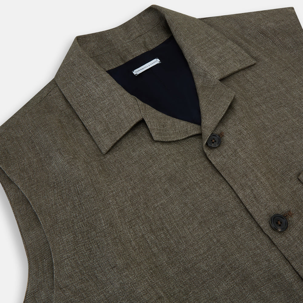 The Turnbull & Asser Olive Collared Linen Waistcoat is a sleeveless olive waistcoat with a collar, front buttons, one chest pocket, and two zippered side pockets, shown against a plain white background.