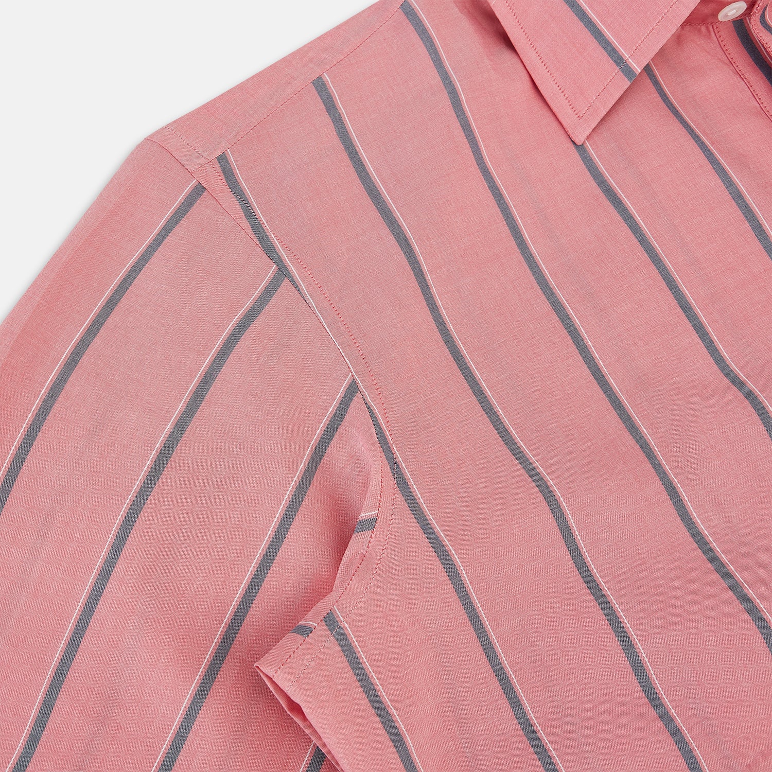 View 6 of product The Coral Pink Track Stripe Westminster Shirt by Turnbull & Asser features vertical navy and white stripes, a tailored fit, pointed collar, and buttoned cuffs—is displayed laid flat on a white background.