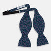 View 2 of product The Turnbull & Asser Multicoloured Dark Navy Circle Silk Bow Tie showcases evenly spaced blue, green, and white ovals—a sophisticated men's accessory perfect for any occasion.