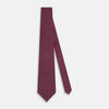 View 2 of product The Turnbull & Asser Red and Purple Miniature Paisley Silk Tie is neatly rolled with the pointed end facing forward.