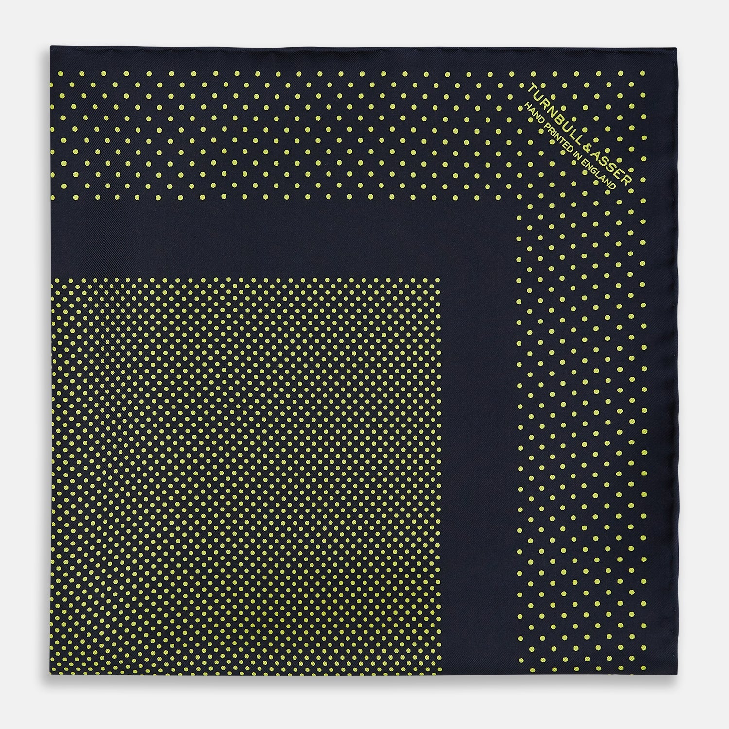 View 3 of product The Turnbull & Asser Navy and Yellow Dot Silk Pocket Square features a navy base with yellow dots, a solid navy border, and a folded corner showing the patterned underside for an elegant accent.