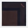 View 4 of product The Navy and Blush Dot Silk Pocket Square by Turnbull & Asser features a navy base with small orange polka dots and a border, shown neatly folded with one corner flipped over.