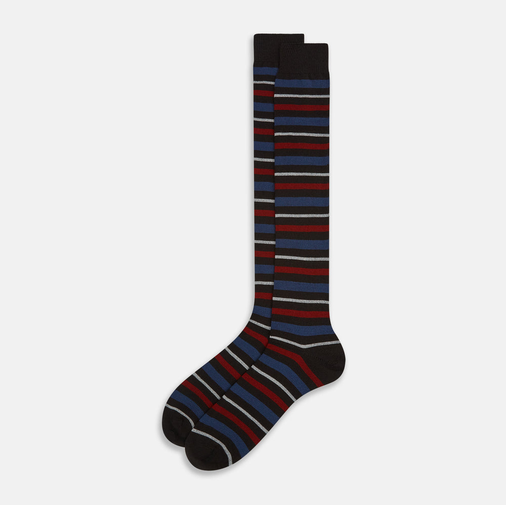 The Turnbull & Asser Dark Chocolate Striped Merino Wool Long Socks are knee-high, featuring horizontal black, red, blue, and gray stripes on a white background.
