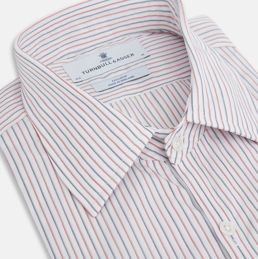 The Turnbull & Asser Red and Blue Double Stripe Westminster Shirt is a long-sleeved, button-up dress shirt with a formal collar, featuring narrow red and blue stripes on white, shown against a plain white background.