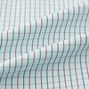 View 8 of product The Turnbull & Asser Forest Melange and Red Overlay Grid Check Westminster Shirt features long sleeves, a pointed collar, and buttoned cuffs, highlighting British craftsmanship. It's shown laid flat against a white background.