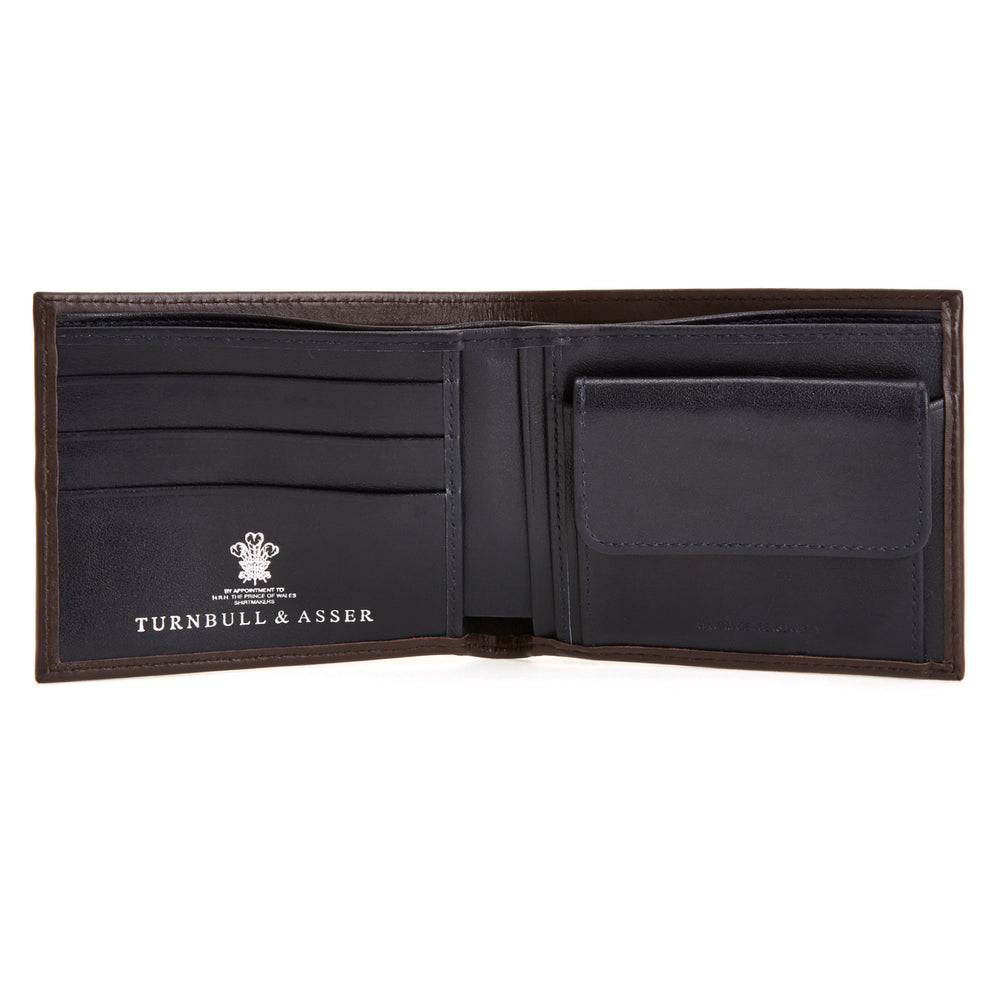 The Turnbull & Asser Brown Bill Coin Wallet is open to reveal its black interior with a coin pocket. The empty wallet is shown against a plain white background.