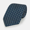 View 1 of product The Turnbull & Asser Navy Diamond Silk Tie features a diamond pattern of small white and yellow squares, embodying British craftsmanship, shown on a plain white background.