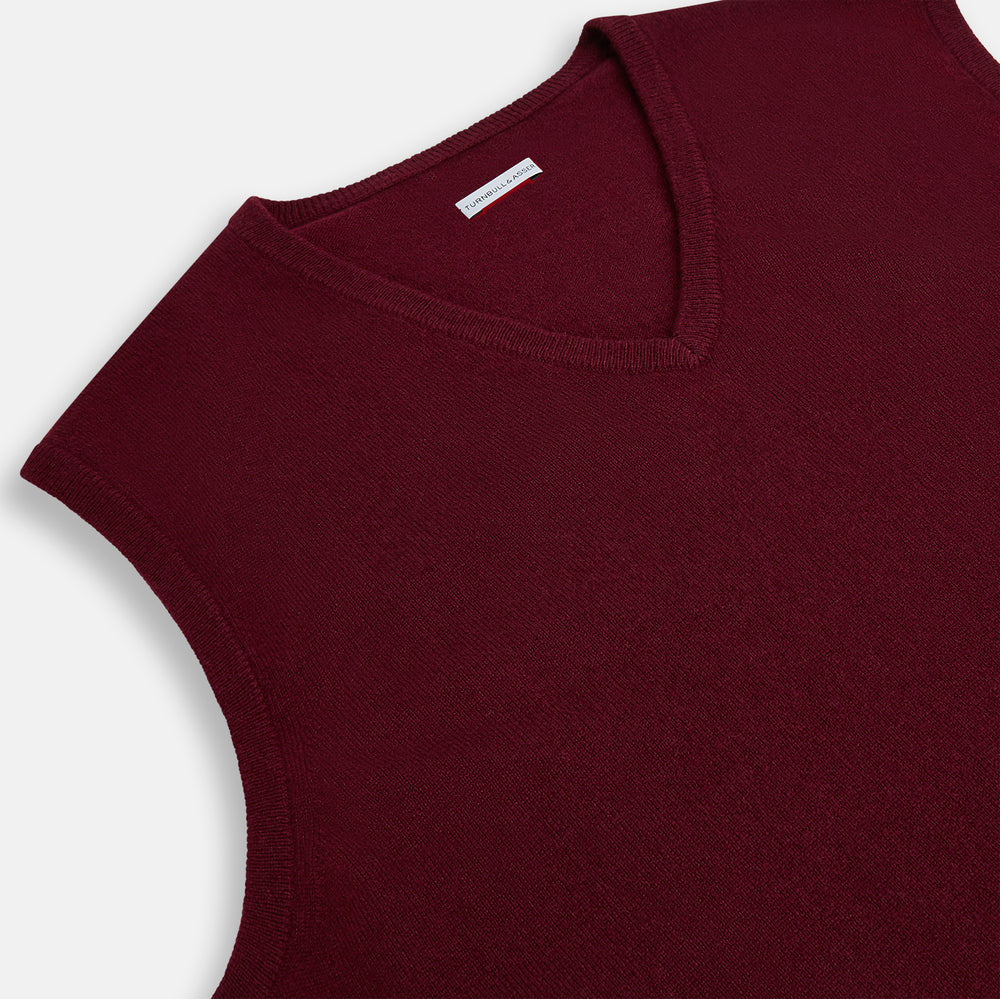 The Turnbull & Asser Burgundy Cashmere V-Neck Vest for men is a stylish, sleeveless knit sweater displayed on a plain white background.