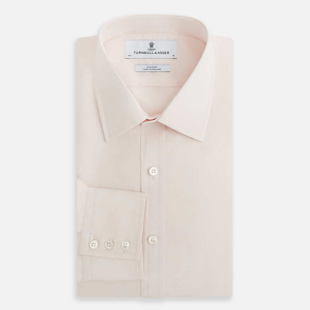 A plain, long-sleeve Pale Pink Mayfair Shirt by Turnbull & Asser with a T&A collar and buttoned cuffs, laid flat on a white background.