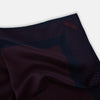 View 2 of product The Turnbull & Asser Navy and Red Dot Silk Pocket Square features a dark navy blue base with small red polka dots on the border and inner pattern, all handmade and neatly folded.