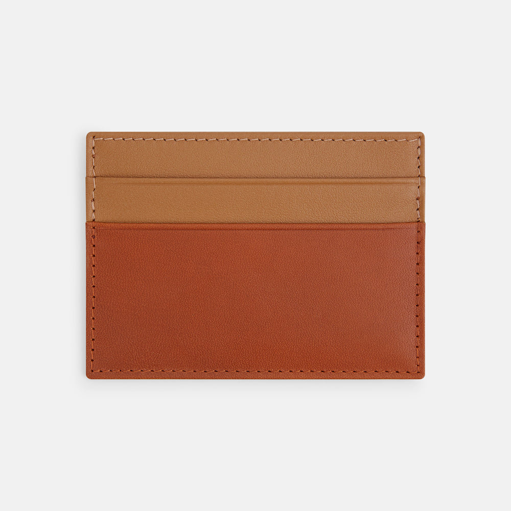 The TAN LEATHER CARD CASE by Turnbull & Asser is a minimalist brown leather wallet with two slots and "Turnbull & Asser Made in England" embossed on the front.