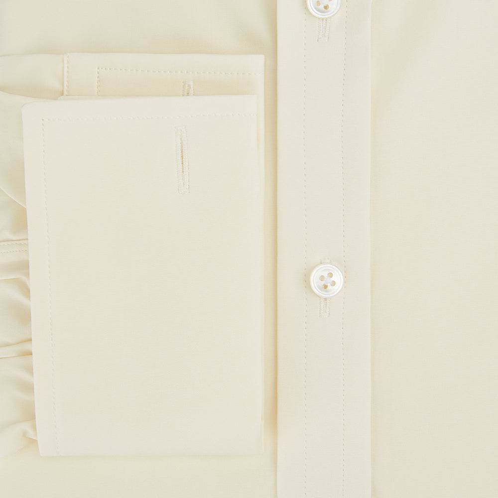 The Turnbull & Asser Cream Cotton Shirt features a T&A collar and double cuffs, elevating men's style. Displayed flat against a white background, this long-sleeve shirt is crafted in classic cream cotton.