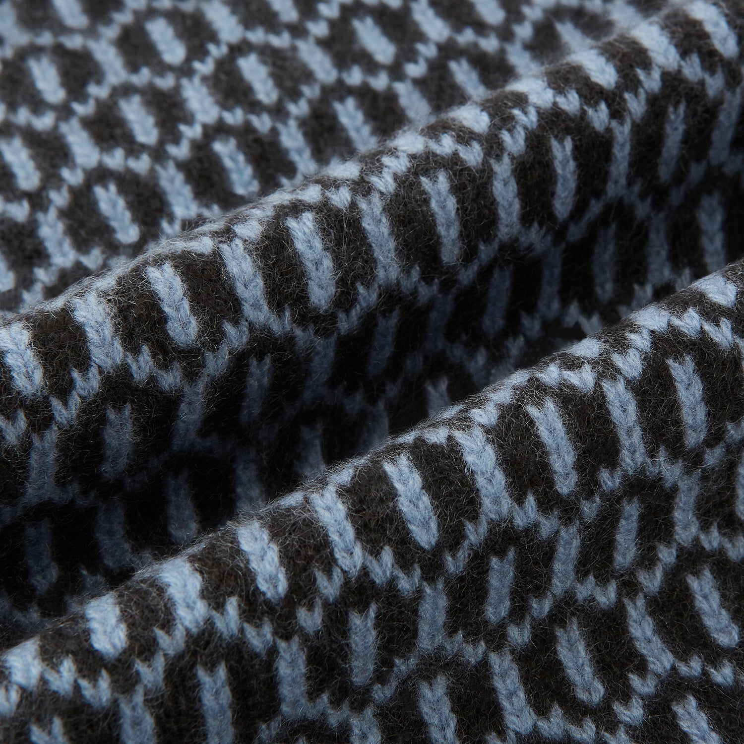 Image 3 of product The Turnbull & Asser Dark Chocolate and Pale Blue Hexagon Cashmere Knitted Scarf is elegantly looped against a white background—an essential geometric accessory for any wardrobe.