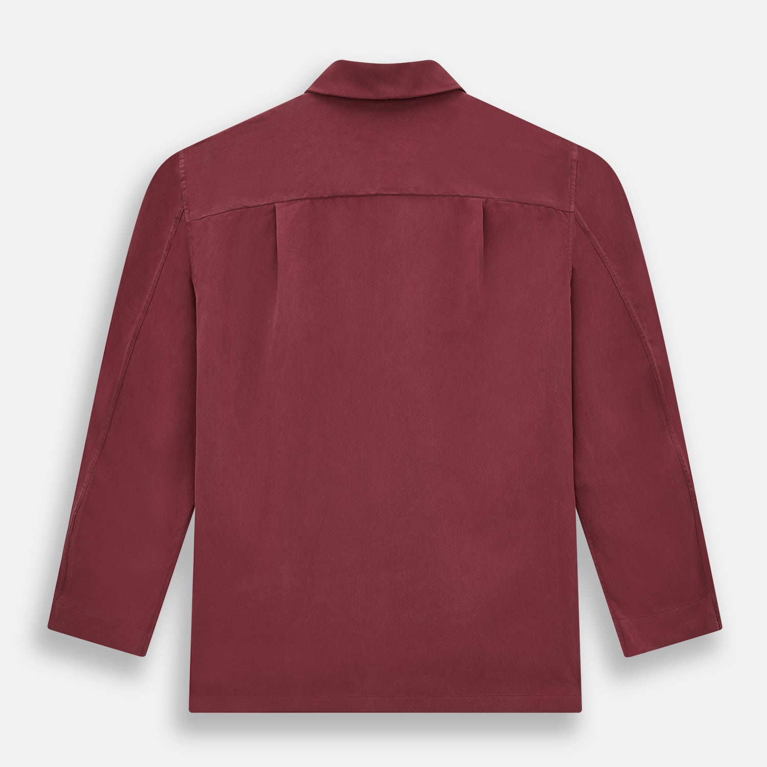 View 5 of product The Turnbull & Asser Burgundy Silk Pyjama Set features a long-sleeve, button-up shirt with chest pocket and matching pants with elastic waistband and side pocket, shown on a white background.