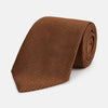 View 1 of product The Turnbull & Asser Plain Lace Jacquard Earth Tie, an essential brown wardrobe accessory, is shown rolled up against a plain white background.