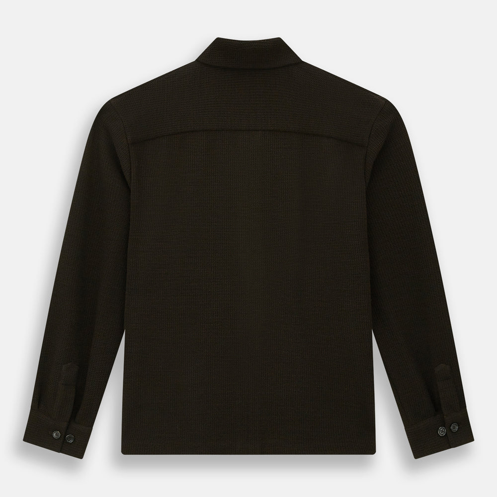 The Turnbull & Asser Dark Chocolate Greenwich Knitted Overshirt is crafted from Italian wool, with a classic collar, two flap chest pockets, and a concealed button front—offering a sleek cardigan alternative. Shown on a white background.