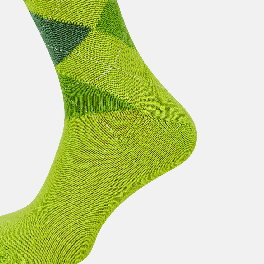 The Lime Check Mid-Length Sock by Turnbull & Asser features a green and yellow argyle pattern with a ribbed cuff, crafted from comfortable cotton material, and is shown on a plain light background.