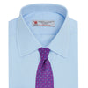 View 4 of product The Turnbull & Asser Light Blue Sea Island Quality Cotton Shirt features a T&A collar, double cuffs, white buttons, and a quality label inside the collar. Displayed on a plain white background.