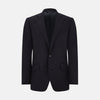 View 3 of product The Turnbull & Asser Short Navy Single Breasted Suit is shown flat on a white background, with a notch lapel jacket featuring two front pockets and matching trousers neatly folded underneath.