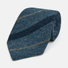 View 1 of product The Blue Multi Stripe Silk Tie by Turnbull & Asser, featuring navy and cream stripes on blue English silk, is shown rolled up against a white background.