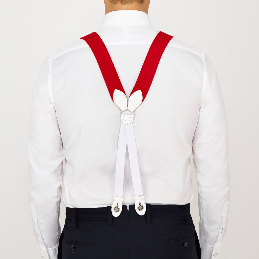 Two Red Adjustable Felt Braces by Turnbull & Asser, featuring white leather ends and silver-tone clasps, made in England from classic boxcloth, are laid flat on a white background.