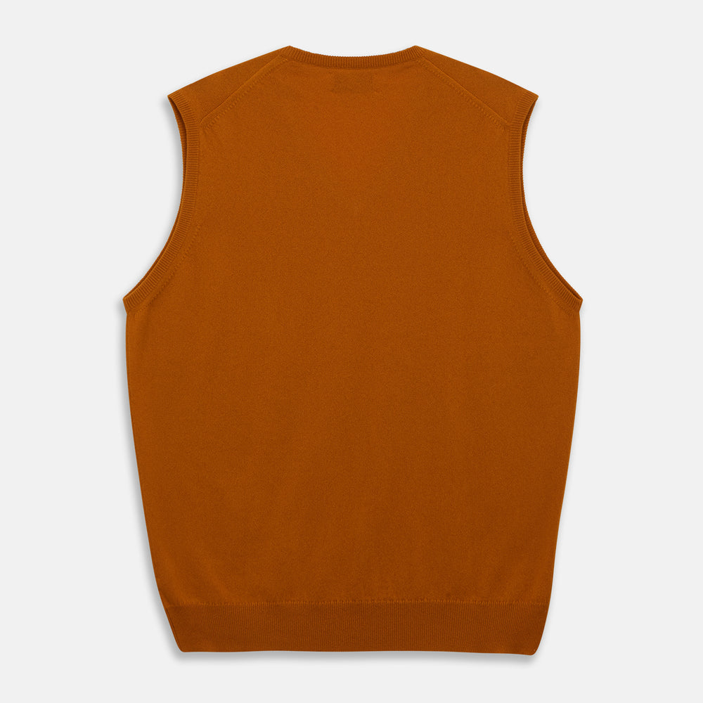 The Rust Ifor Slipover by Turnbull & Asser, a sleeveless V-neck in burnt orange, is made from lightweight Scottish cashmere and displayed flat on a white background.