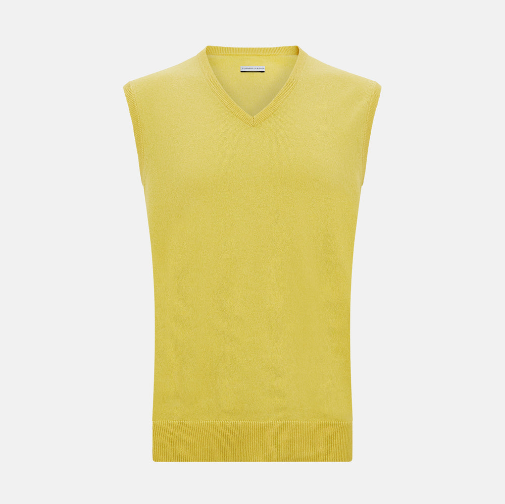 Turnbull & Asser’s Canary Yellow Cashmere V-Neck Vest features a ribbed hem and sleeveless design, adding a vibrant touch to refined outfits. Displayed on a plain white background.