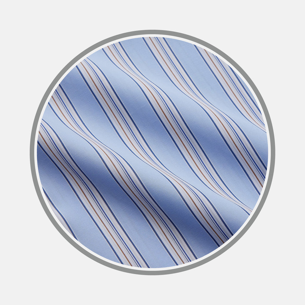 Close-up of Turnbull & Asser's Pale Blue Multi-stripe Cotton Fabric, featuring diagonal white, navy, and tan stripes displayed in a circular frame against a plain white background.