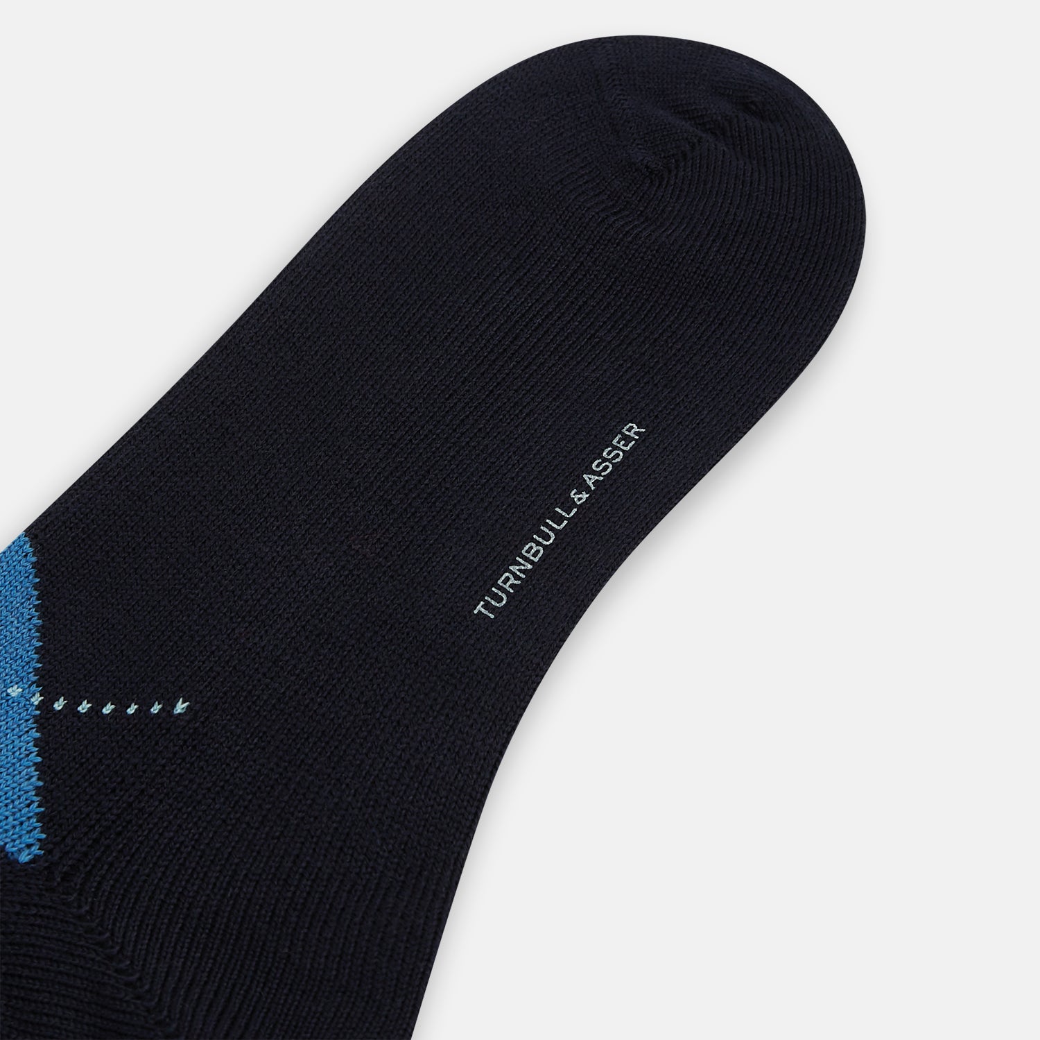 View 3 of product A single Turnbull & Asser Navy/Blue Wool Check Mid-Length Sock, featuring a blue and light blue check pattern, is displayed upright on a plain white background.