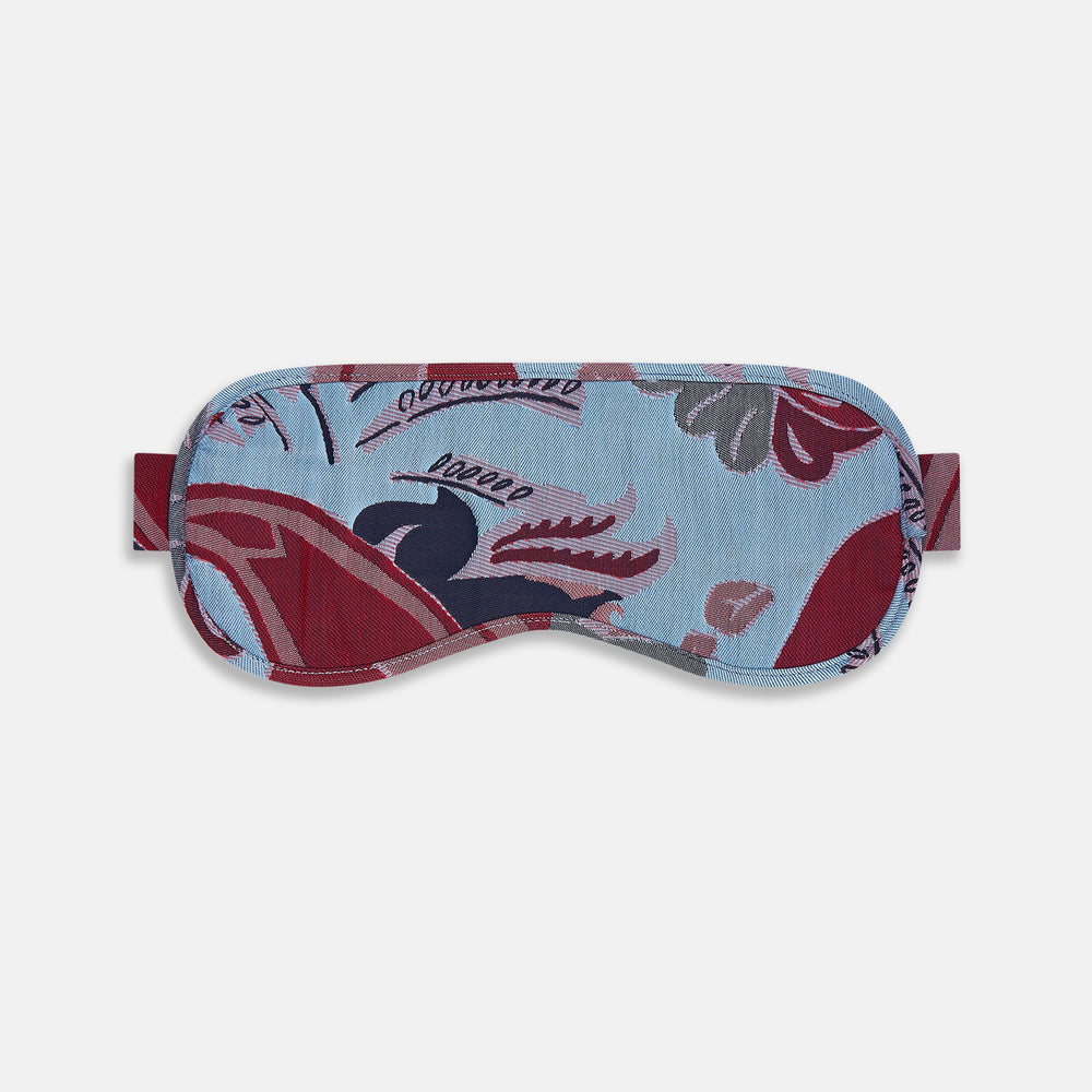 The Blue Bloomsbury Jacquard Cashmere Lined Sleep Mask and Bag by Turnbull & Asser features a blue and red abstract floral pattern, elastic strap, and is shown on a plain white background.