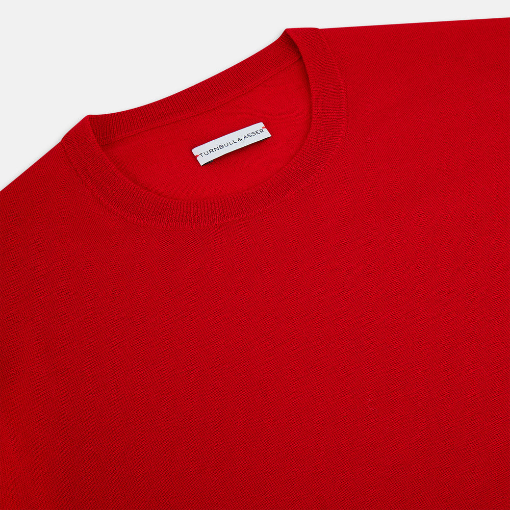The Turnbull & Asser Red Merino Round Neck Jumper features long sleeves, ribbed cuffs and hem—a classic men's knitwear essential shown on a white background.