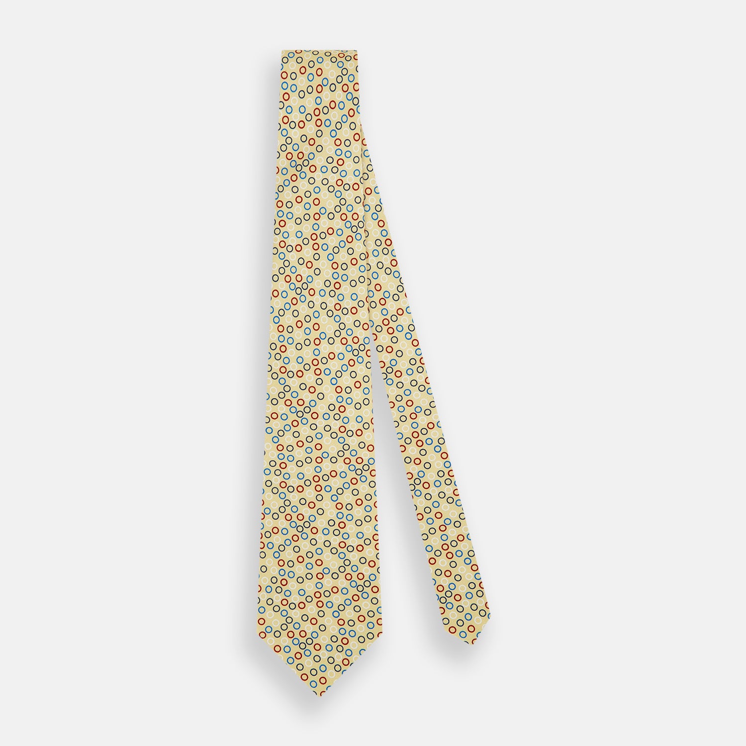 View 2 of product The Turnbull & Asser Multi-coloured Circle Yellow Printed Silk Tie features vibrant blue, red, and black circles evenly spaced across luxurious English silk.