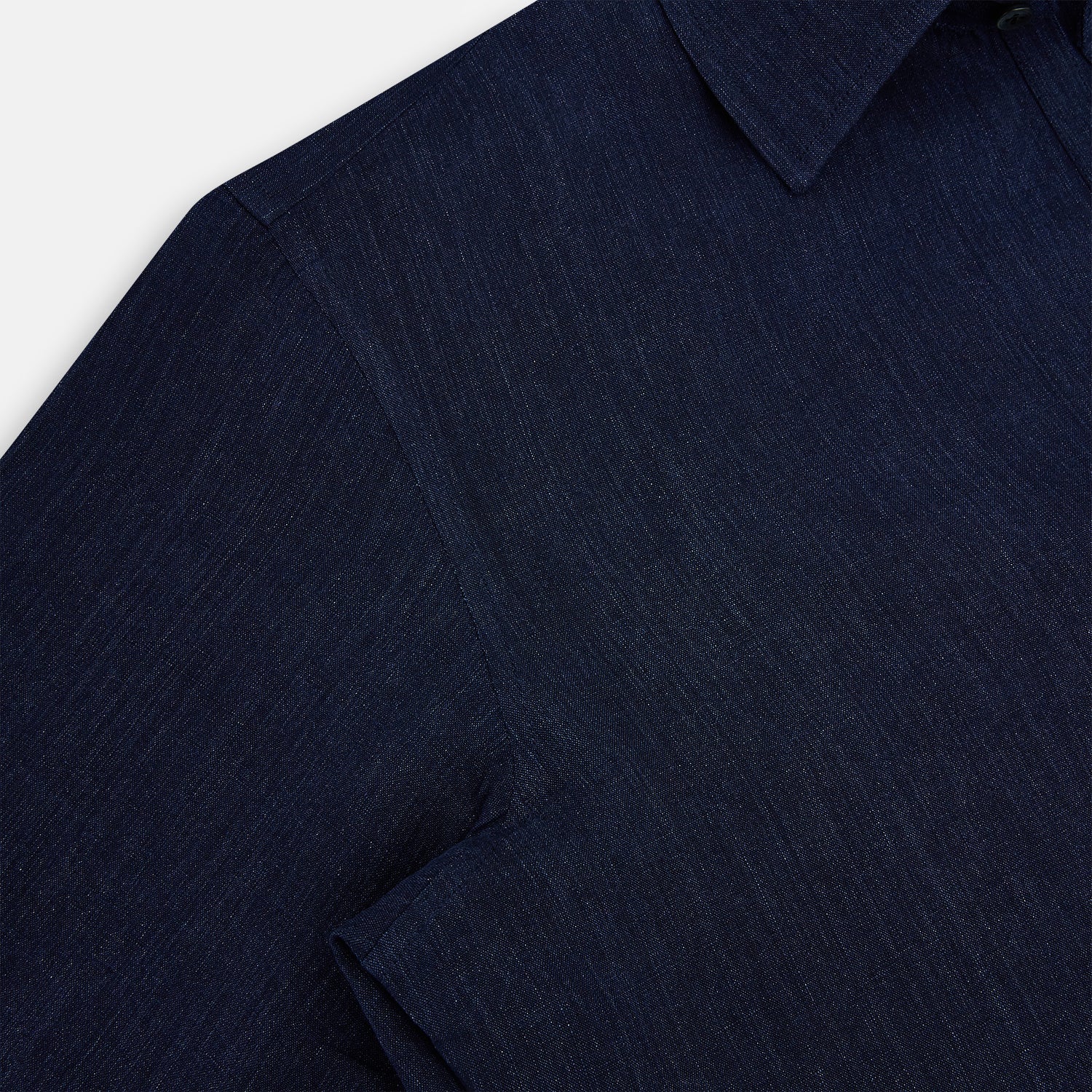 View 6 of product The Navy Linen Westminster Shirt by Turnbull & Asser features a classic collar and buttoned cuffs, exemplifying British craftsmanship. Shown here in long sleeves, the shirt is displayed flat against a white background.