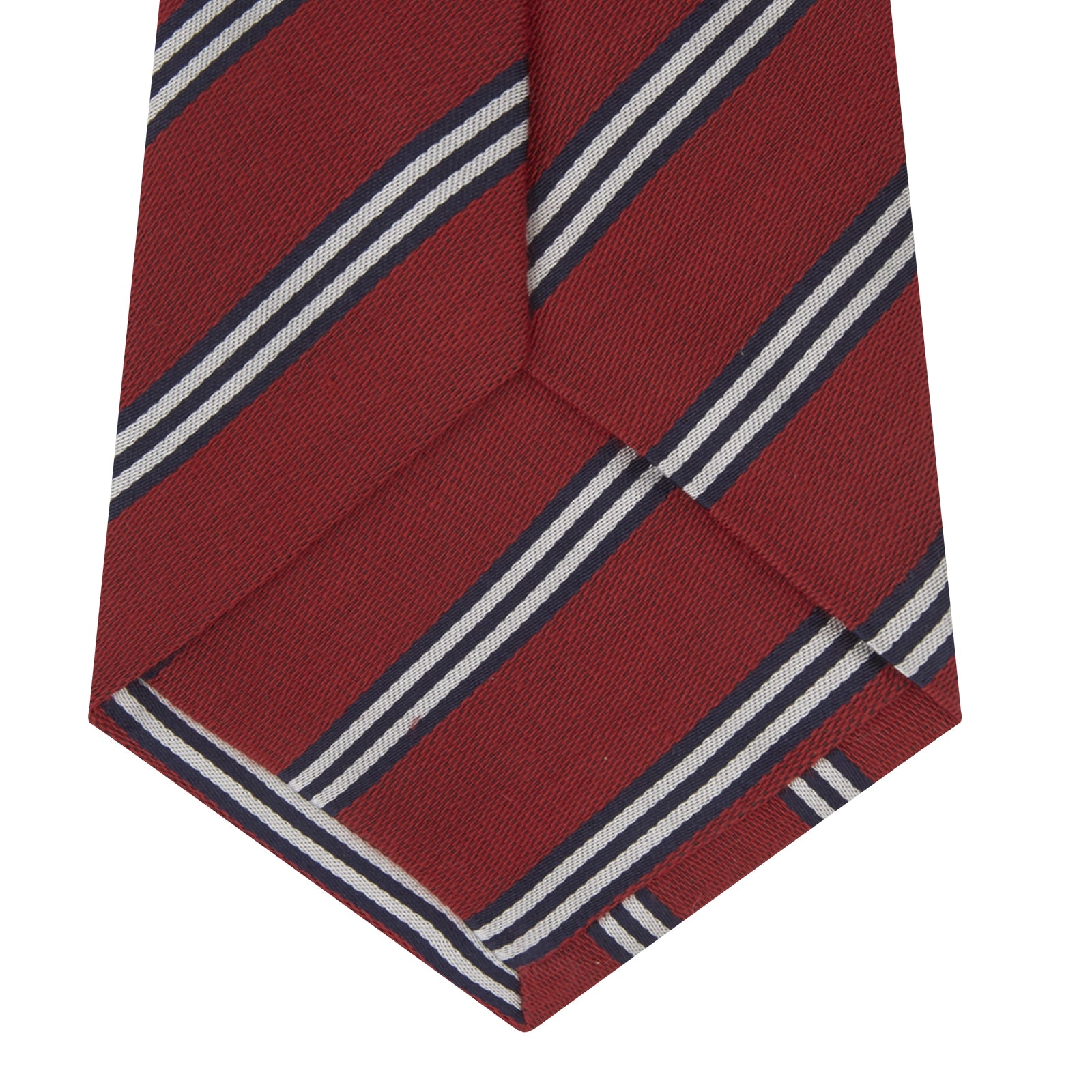 View 4 of product The Turnbull & Asser GGT92000 3042 48 OS is a rolled-up red cotton silk stripe tie with diagonal white and navy blue stripes, displayed on a plain white background.