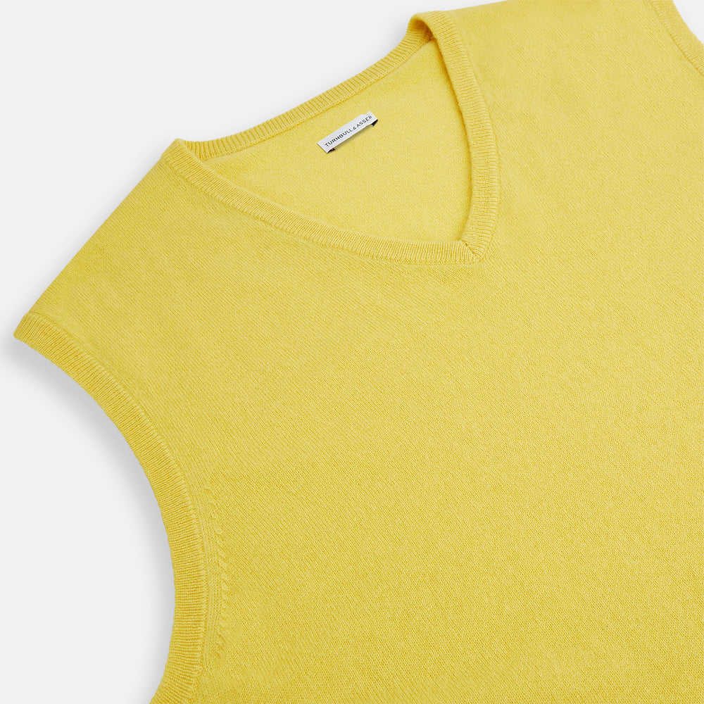 Turnbull & Asser’s Canary Yellow Cashmere V-Neck Vest features a ribbed hem and sleeveless design, adding a vibrant touch to refined outfits. Displayed on a plain white background.