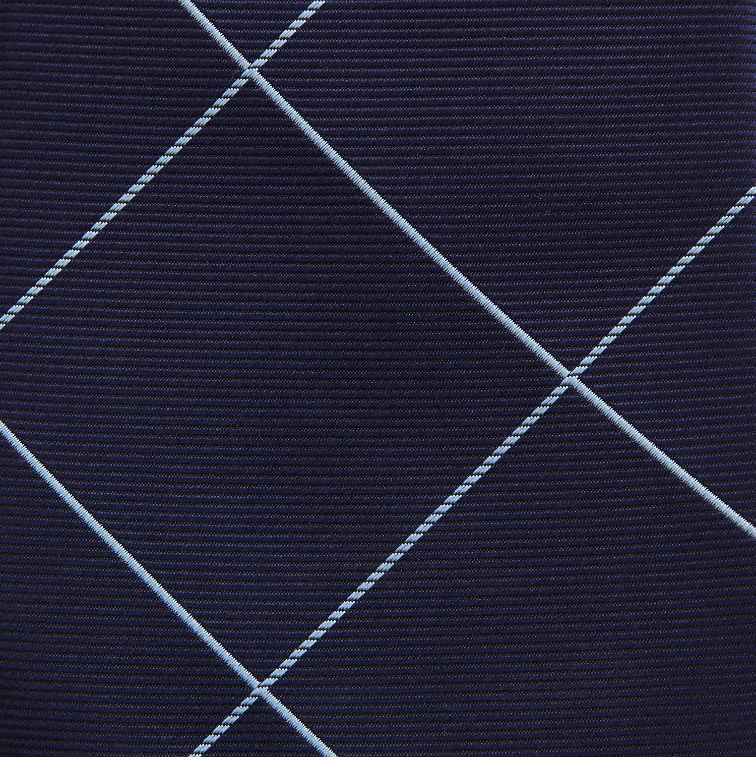 View 3 of product The Turnbull & Asser WINDOW PANE NAVY RIVER TIE features a navy blue base with a subtle light blue check pattern, elegantly rolled on a white background—a sophisticated men's accessory for any wardrobe.